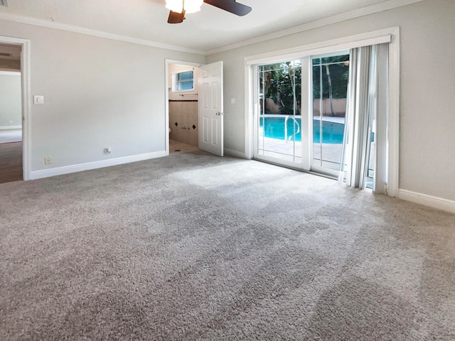 carpeted empty room featuring ceiling fan and crown molding