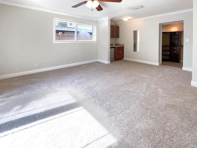 unfurnished living room featuring carpet, ceiling fan, and crown molding