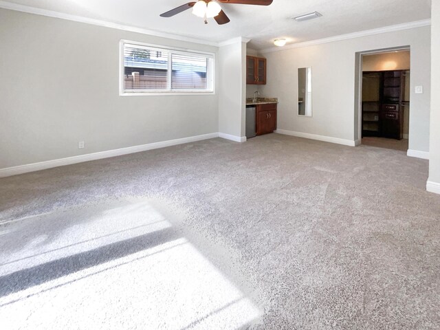 232 NW 25th St, Wilton Manors, FL 33311 - unfurnished living room with crown molding, a ceiling fan, light carpet, baseboards, and a sink