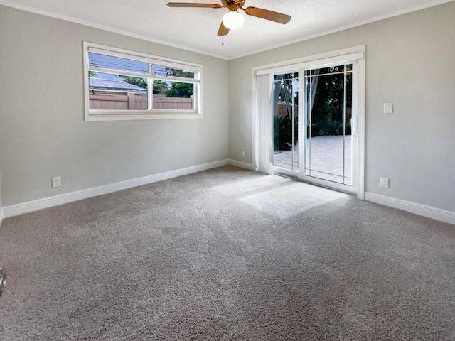 carpeted spare room featuring ceiling fan and crown molding