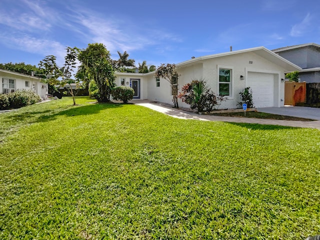 ranch-style house featuring a garage and a front yard