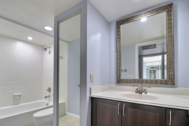 full bathroom featuring vanity, tile patterned floors, tiled shower / bath combo, and toilet