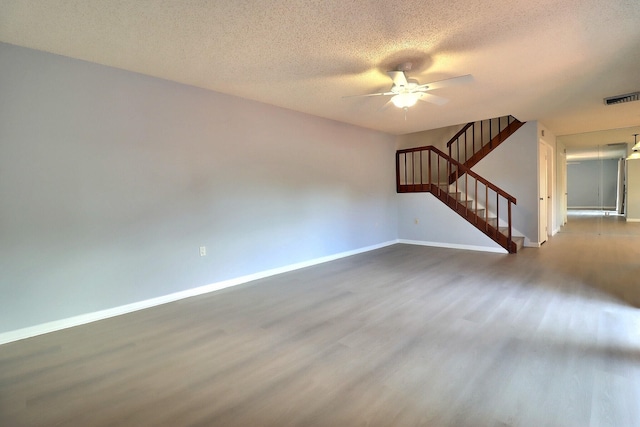 unfurnished room featuring ceiling fan, a textured ceiling, and hardwood / wood-style flooring