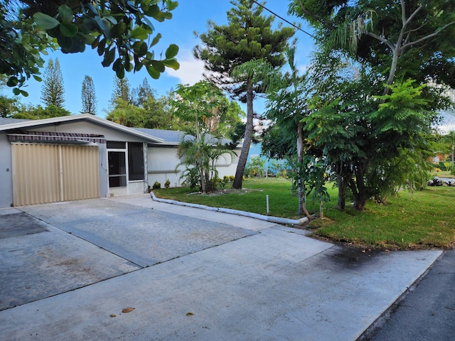 view of front of home with a front lawn and a sunroom