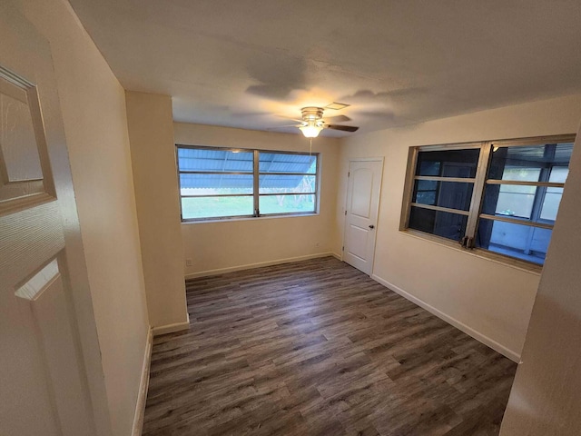 empty room featuring ceiling fan and dark hardwood / wood-style flooring