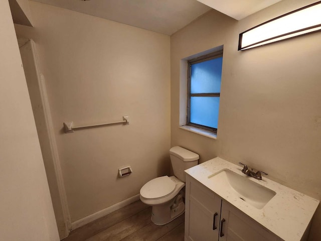 bathroom with vanity, hardwood / wood-style flooring, and toilet