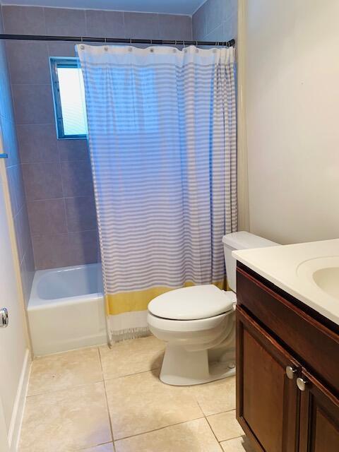 2727-29 NE 30th Ave, Lighthouse Point, FL 33064 - full bath featuring vanity, tile patterned floors, and shower / bath combo with shower curtain