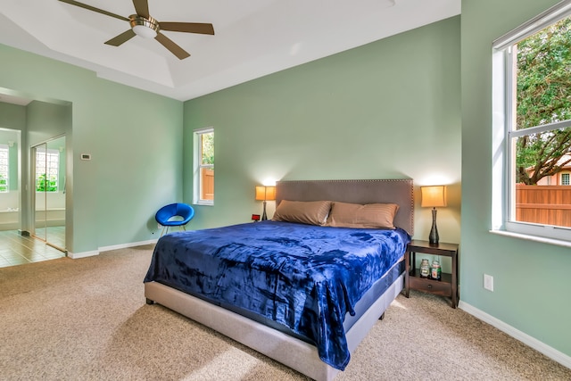 bedroom featuring ceiling fan and light carpet