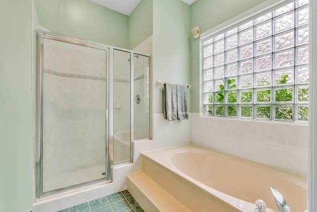 bathroom featuring tile patterned flooring and plus walk in shower