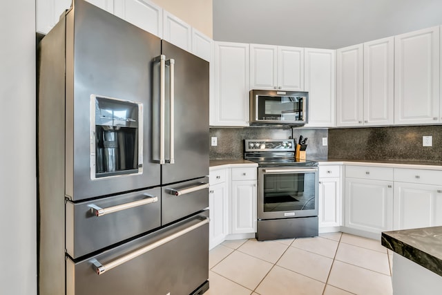 kitchen featuring light tile patterned flooring, white cabinetry, and appliances with stainless steel finishes