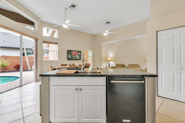 kitchen featuring stainless steel dishwasher, ceiling fan, sink, light tile patterned floors, and white cabinetry