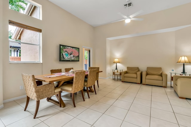 tiled dining area featuring ceiling fan and high vaulted ceiling