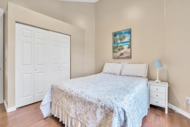 bedroom with a closet and hardwood / wood-style flooring