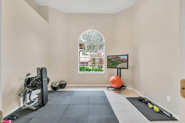 exercise room with light tile patterned floors