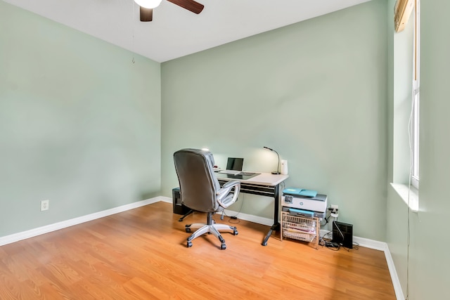 office with hardwood / wood-style floors and ceiling fan