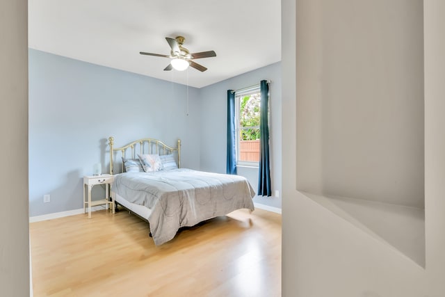 bedroom with ceiling fan and hardwood / wood-style flooring