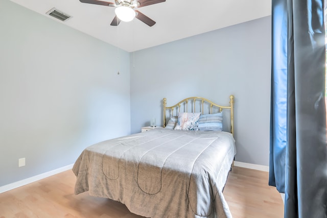 bedroom with light hardwood / wood-style flooring and ceiling fan