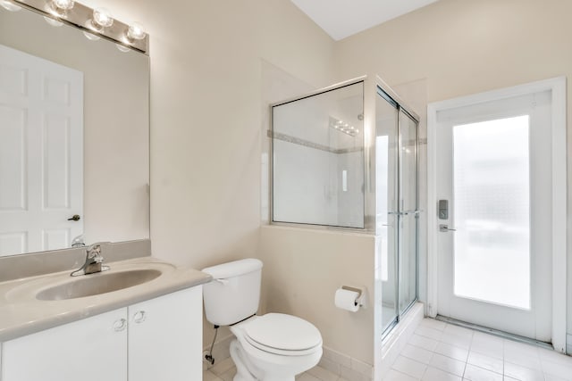 bathroom featuring plenty of natural light, vanity, an enclosed shower, and tile patterned flooring