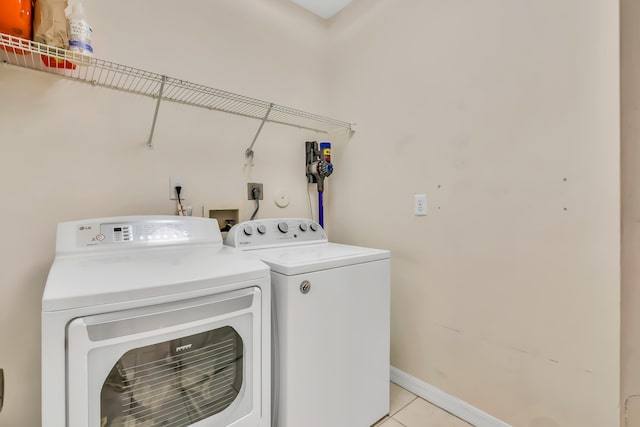 washroom featuring light tile patterned floors and washer and dryer