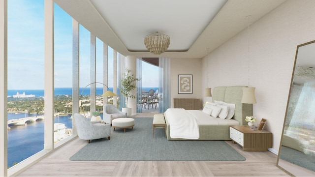 bedroom with a chandelier, a water view, and light hardwood / wood-style floors