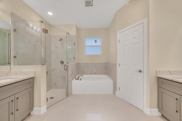 bathroom featuring independent shower and bath, tile patterned floors, and vanity