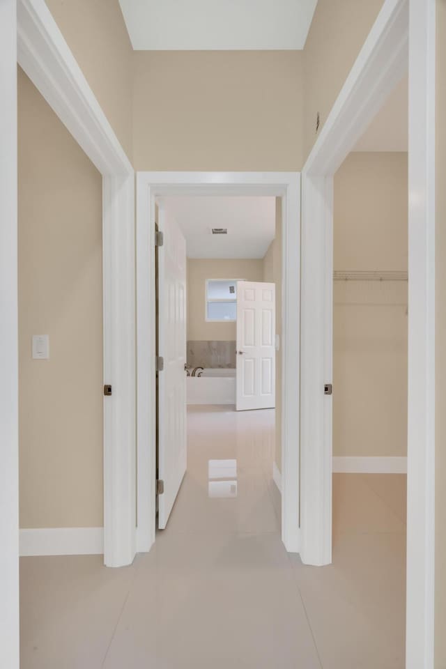 corridor with tile patterned flooring