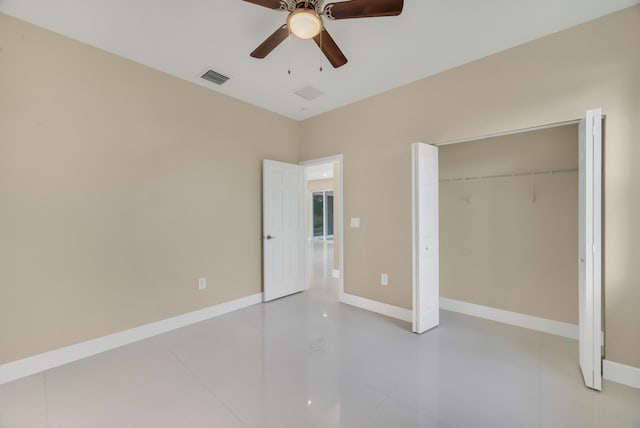 unfurnished bedroom featuring ceiling fan, a closet, and light tile patterned flooring