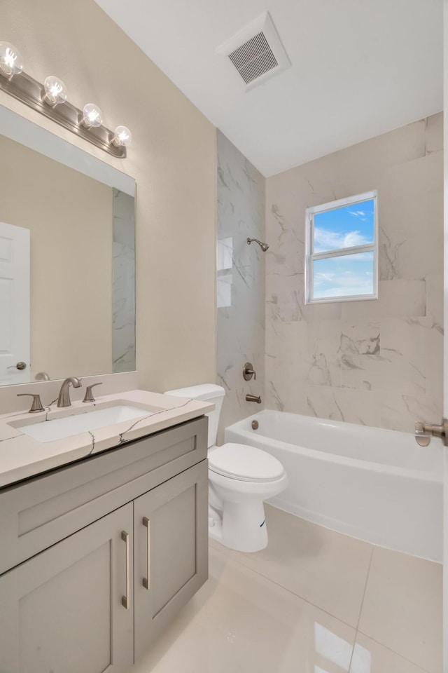 full bathroom with toilet, tiled shower / bath, tile patterned flooring, and vanity