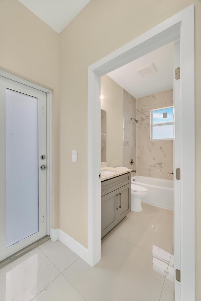 full bathroom featuring tile patterned floors, toilet, vanity, and tiled shower / bath