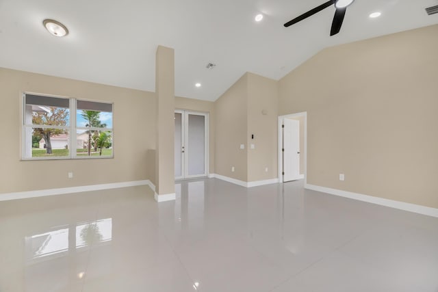 empty room featuring ceiling fan, lofted ceiling, and tile patterned floors