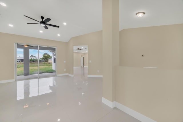 tiled spare room with ceiling fan and vaulted ceiling