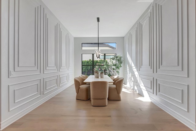 dining room featuring light hardwood / wood-style floors and an inviting chandelier