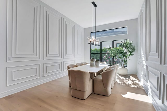 dining area featuring a chandelier and light hardwood / wood-style floors