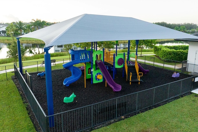 view of jungle gym with a water view and a lawn