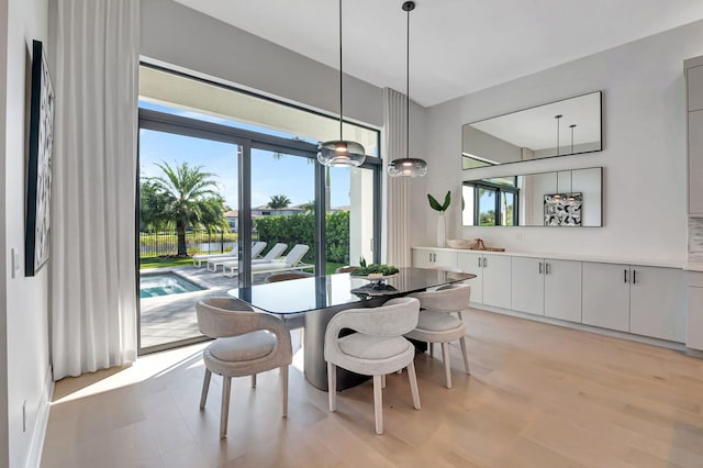 dining space featuring light wood-type flooring