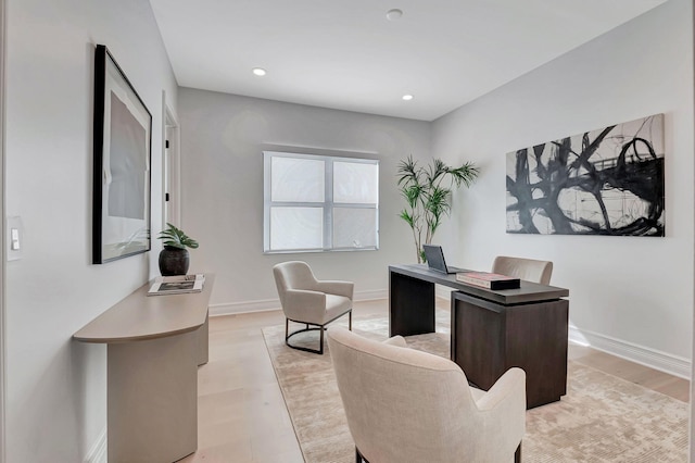 home office with light hardwood / wood-style floors