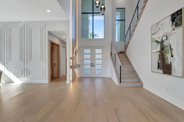 foyer featuring french doors and light hardwood / wood-style floors