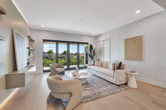 living room featuring french doors and light hardwood / wood-style flooring