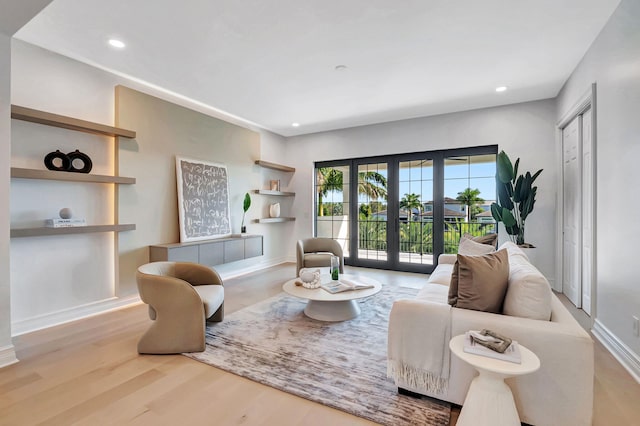 living room featuring light wood-type flooring and french doors