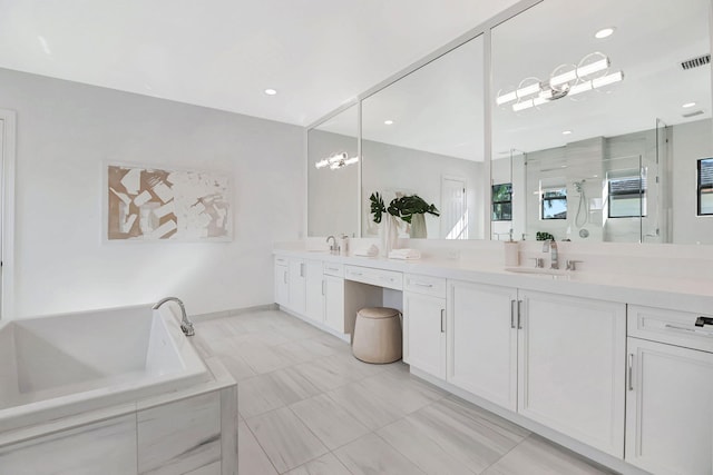 bathroom featuring shower with separate bathtub and vanity