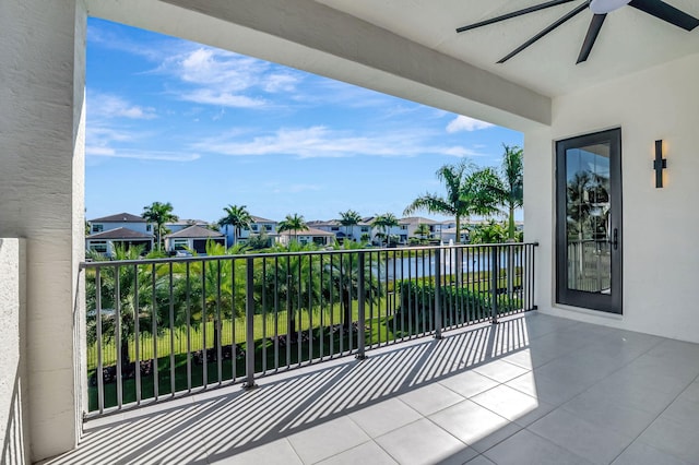 balcony with a water view and ceiling fan