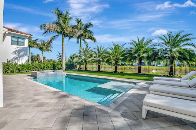 view of swimming pool featuring a lawn, an in ground hot tub, and a patio