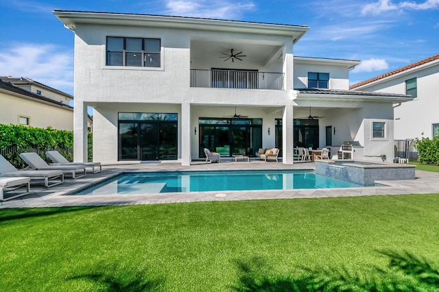 rear view of property with a lawn, a patio area, ceiling fan, and a balcony