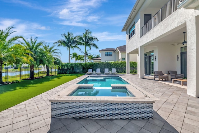 view of pool with a lawn, an in ground hot tub, and a patio