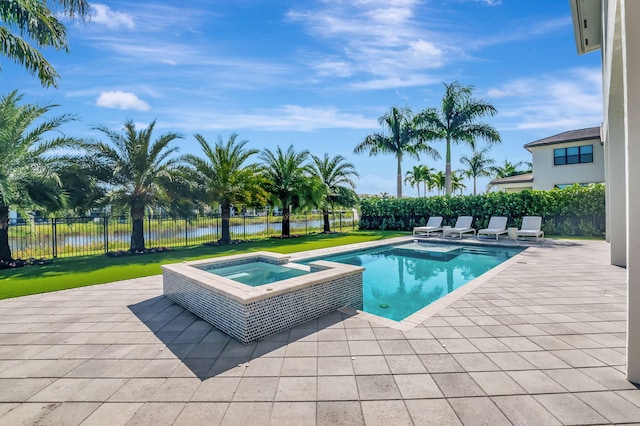 view of pool featuring an in ground hot tub, a yard, a water view, and a patio area