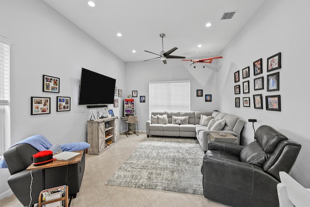 living room with ceiling fan, light tile patterned floors, and high vaulted ceiling