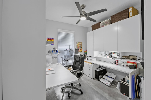 office area featuring light carpet and ceiling fan