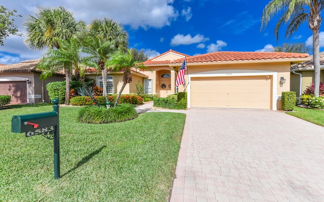 mediterranean / spanish house featuring a front lawn and a garage