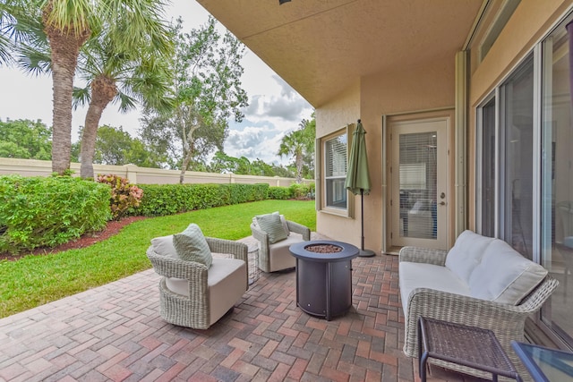 view of patio / terrace with an outdoor living space with a fire pit