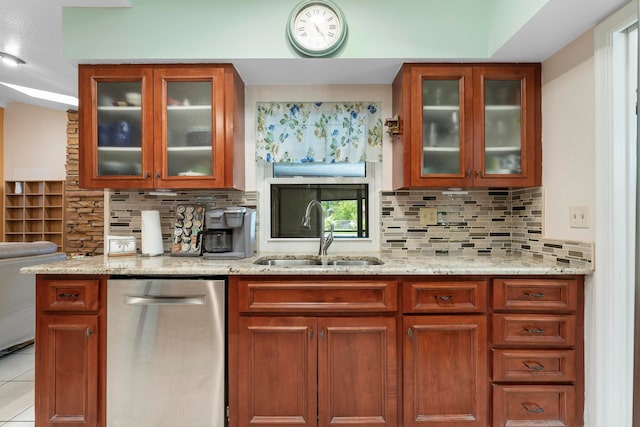 kitchen with dishwasher, sink, light stone countertops, tasteful backsplash, and light tile patterned flooring